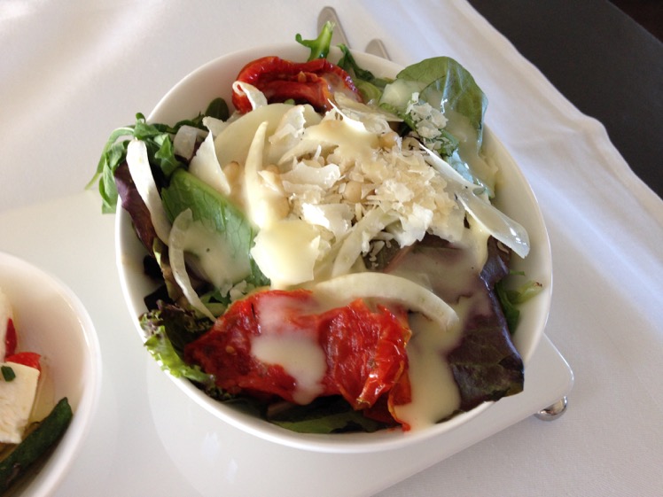 Seasonal fresh salad shaved Fennel, Pine Nuts, roasted Red Tomato and Parmesan Cheese presented with Dressing