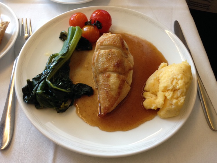 Apricot butter-filled breast of chicken with jus, sautéed broccoli rabe, vine cherry tomatoes and Parmesan polenta
