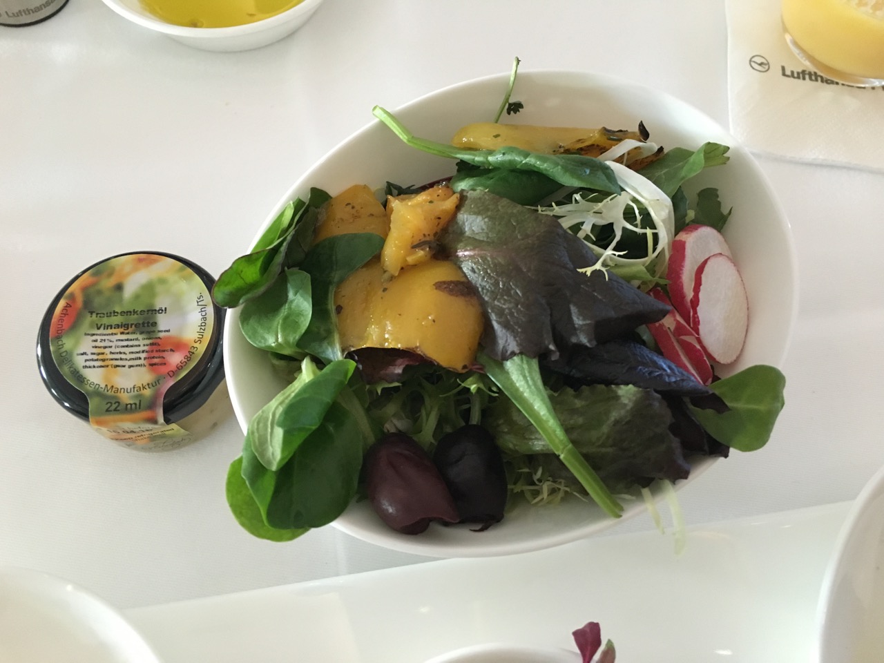 Mixed Leaf Lettuce with Red Radish, grilled Bell Pepper and Olives accompanied by Grape Seed Oil Vinaigrette