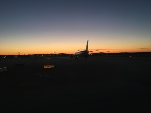 an airplane on a runway at sunset