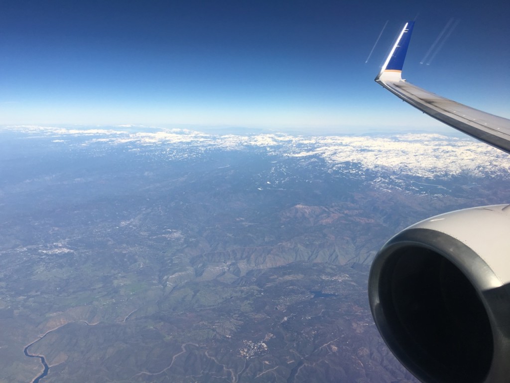 an airplane wing and a view of the earth from the window of an airplane