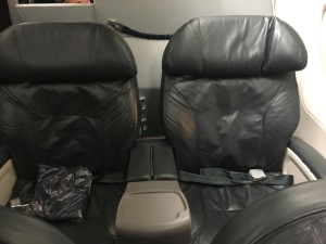two black leather seats in a plane